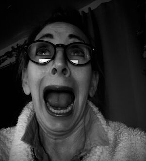Woman with wild expression in black and white selfie,