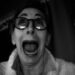Woman with wild expression in black and white selfie,